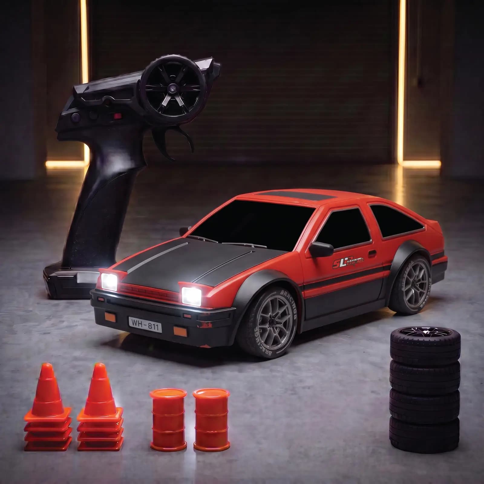 The red classic coupe with its headlights on, next to the remote, four spare wheels, eight cones and two barrels