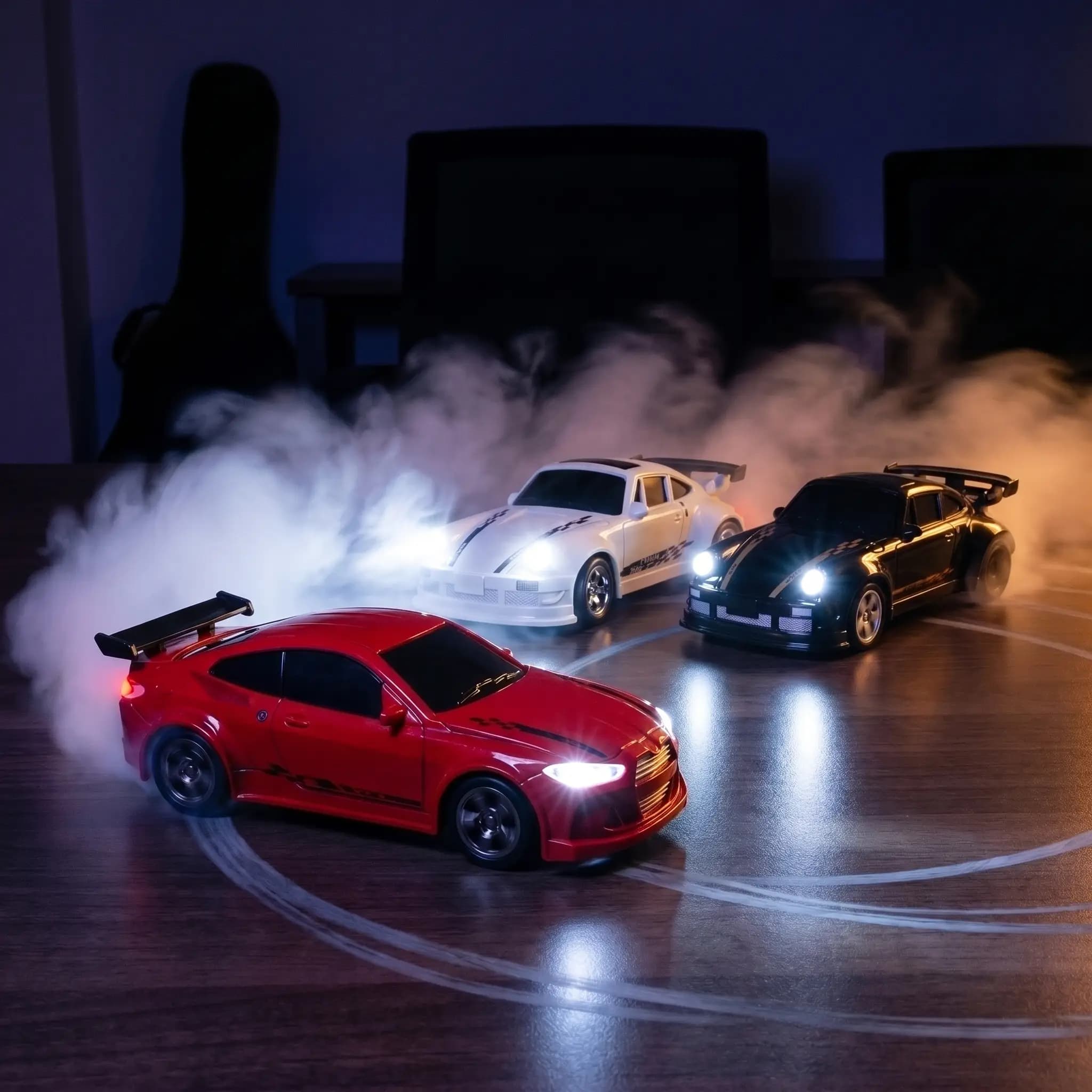 Three DeskDrift Pro RC drift cars drifting at night on a desk, headlights blazing through tyre smoke